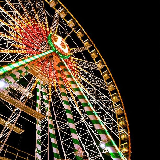 amusement park, amusement park ride, arts culture and entertainment, ferris wheel, low angle view, night, metal, built structure, architecture, illuminated, sky, outdoors, clear sky, metallic, no people, traveling carnival, big wheel, fun, large, pattern