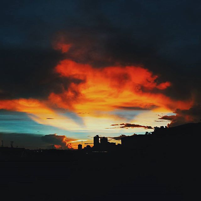 sunset, silhouette, sky, orange color, cloud - sky, building exterior, dramatic sky, beauty in nature, scenics, built structure, cloudy, architecture, nature, dusk, cloud, tranquility, dark, tranquil scene, weather, moody sky