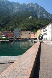 Scenic view of river by mountains against sky