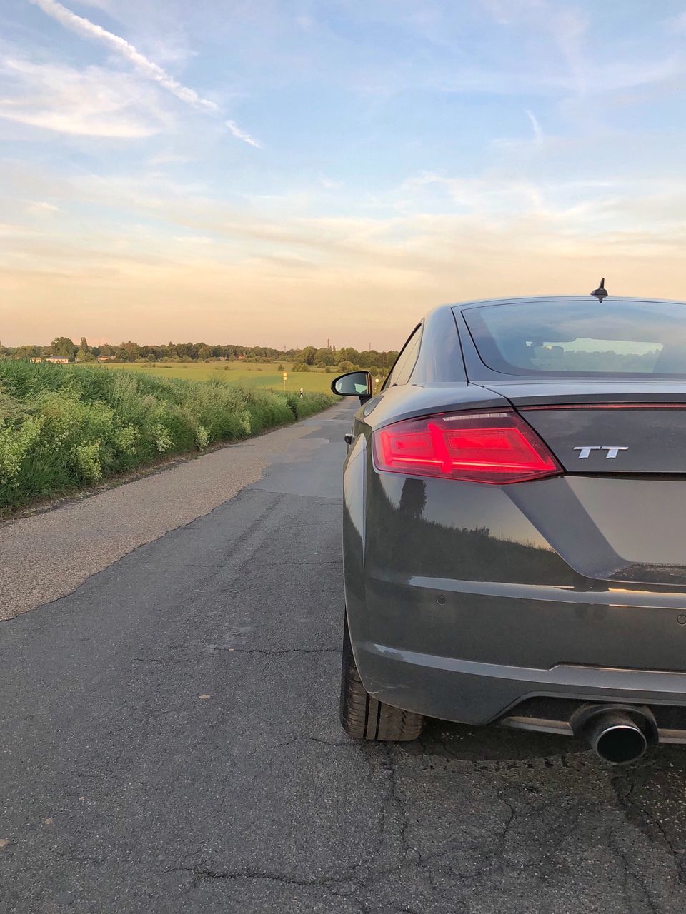 CAR ON STREET AGAINST SKY