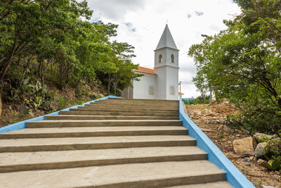 Staircase leading towards temple against sky