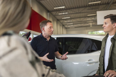 Customers in car dealership office