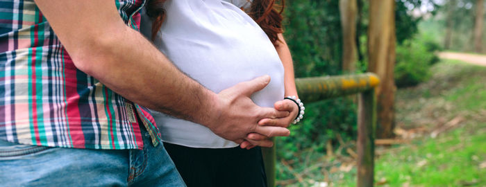 Midsection of woman standing outdoors