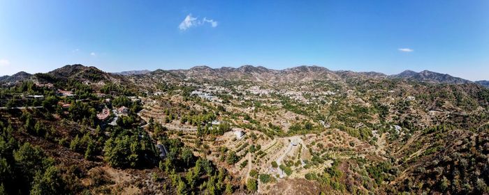 Scenic view of mountains against blue sky