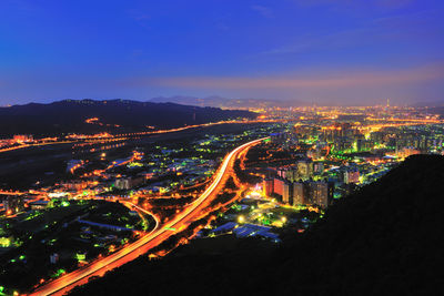 High angle view of illuminated cityscape at night