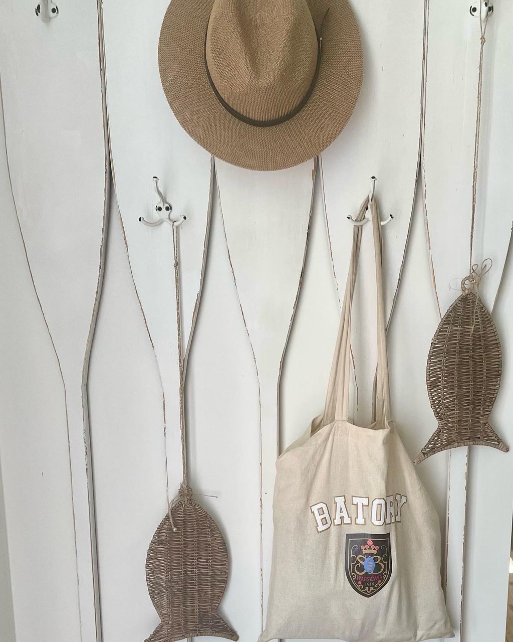 hanging, hat, fashion accessory, cowboy hat, clothing, no people, indoors, straw hat, sun hat, kitchen utensil, still life, wood, group of objects