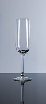 Close-up of wineglass on table against white background