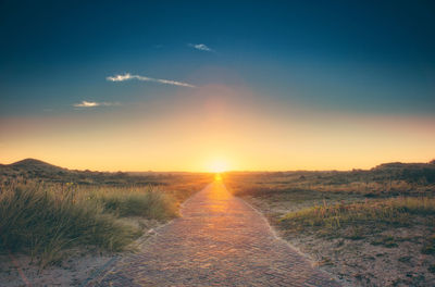 Scenic view of field against sky during sunset