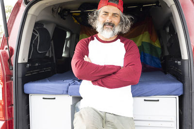 Rear view of man standing in car