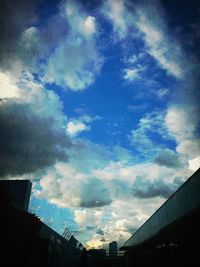 Low angle view of buildings against cloudy sky