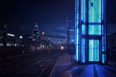 Railroad station platform against sky at night 