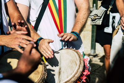 Midsection of men playing musical instrument