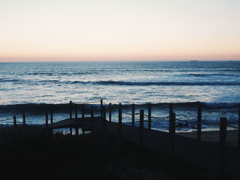 Scenic view of sea against clear sky during sunset