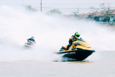 People riding motor boat in water