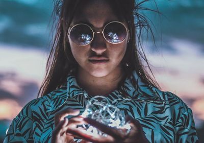 Close-up of young woman holding string light