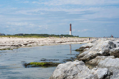 A view of the majestic barnegat lighthouse on the shore.