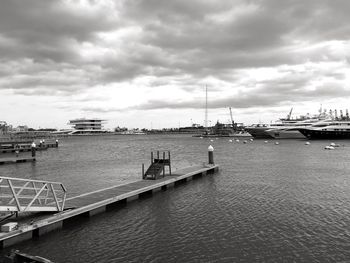 View of harbor against cloudy sky