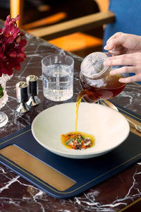 Cropped hand of woman having food