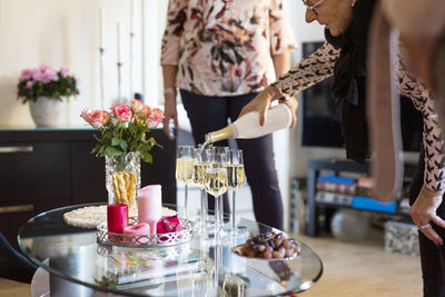 Senior woman pouring champagne