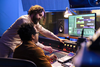 Rear view of woman using sound mixer