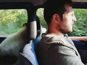 Portrait of man sitting in car