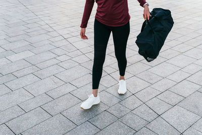 Low section of women walking on footpath