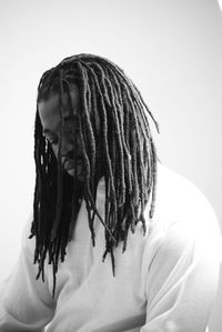 Close-up of man looking away against white background