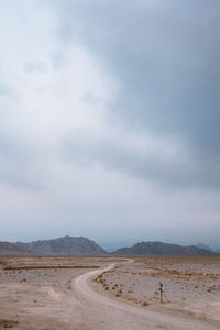 Scenic view of land road against sky