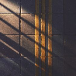 High angle view of sunlight falling on tiled floor