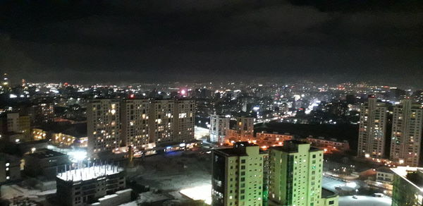 High angle view of illuminated buildings in city at night