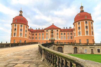 View of buildings against cloudy sky