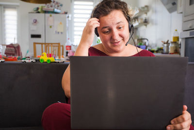 Portrait of mid adult man using mobile phone at home