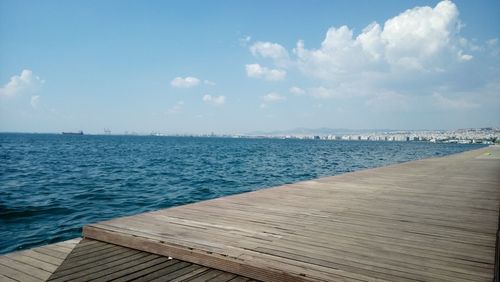 Scenic view of calm sea against cloudy sky