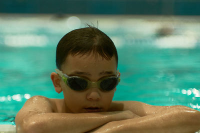 Portrait of shirtless boy swimming in pool