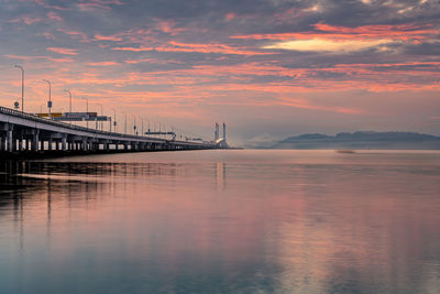 Beautiful sunrise over busy penang bridge, penang, malaysia.