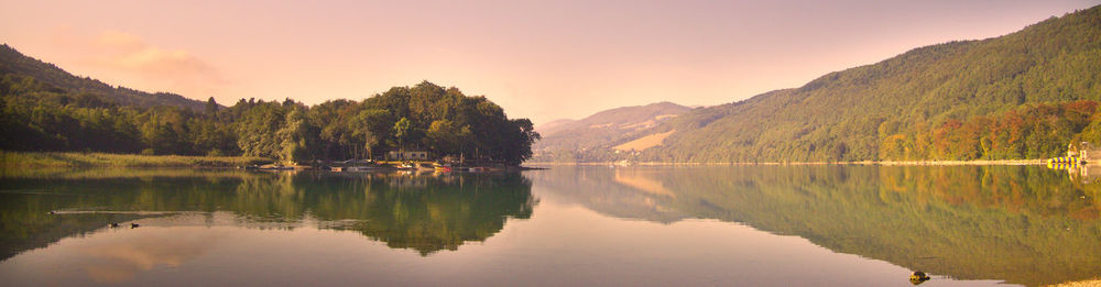 Scenic view of lake and mountains against sky