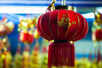 Close-up of red lantern hanging on clothesline