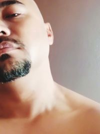 Close-up portrait of shirtless man