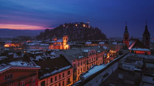 High angle view of illuminated buildings against sky during winter