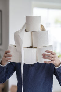 Person holding toiler paper rolls