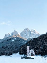 Buildings against mountain range during winter