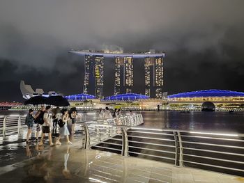 People in illuminated city at night