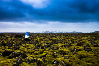 Scenic view of field against cloudy sky