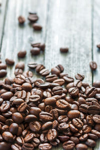 Close-up of coffee beans on aged wooden table