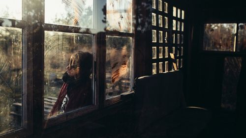 Man seen through window at home