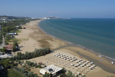 High angle view of sea and buildings against sky
