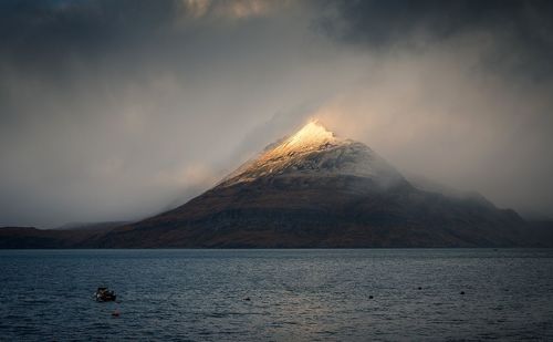 Scenic view of lake against mountain and sky