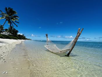 Scenic view of beach against clear blue sky