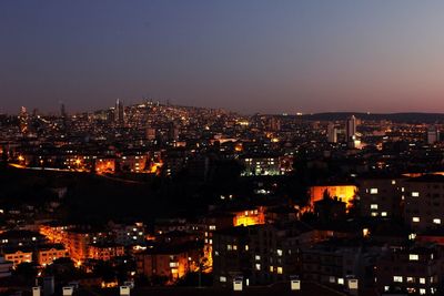 High angle view of illuminated buildings in city at night