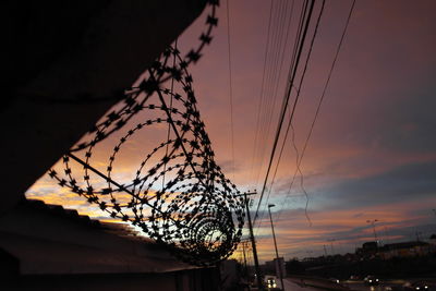 Low angle view of trees against sky at sunset